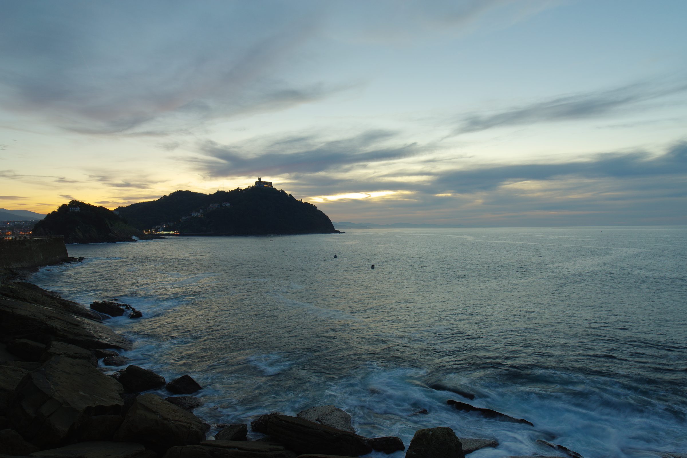 Santa Clara Island and Monte Urgull at dusk, seen from the Paseo Nuevo in San Sebastián.