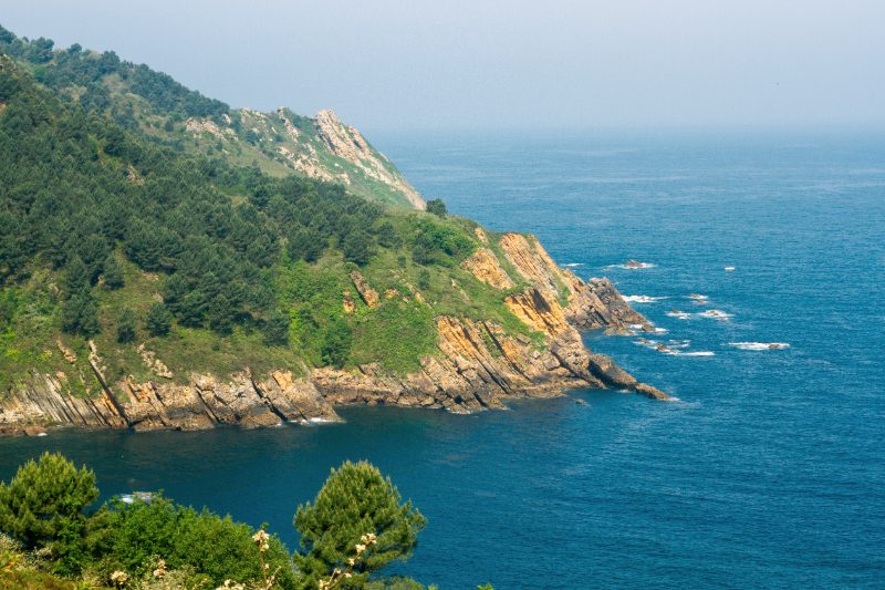 The green headland of Monte Ulía dropping into the Bay of Biscay, seen from the coastal trail east of San Sebastián.